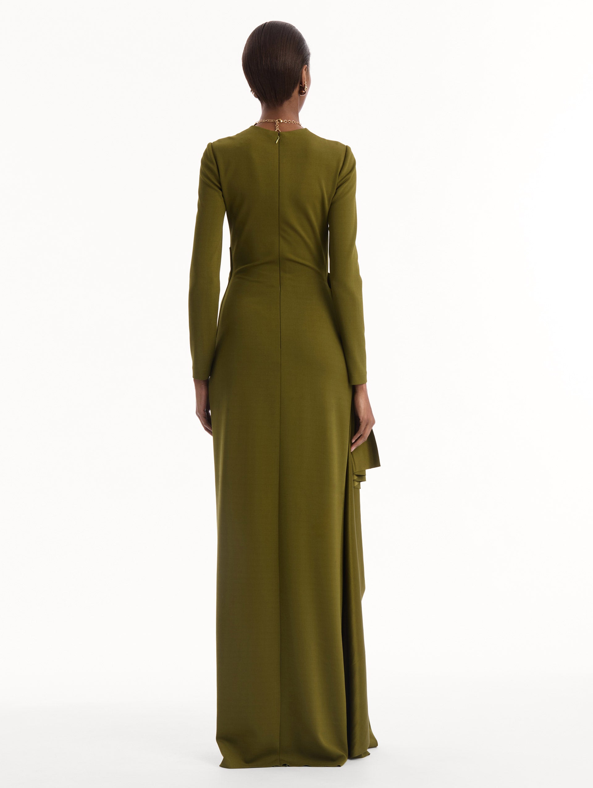 The model is wearing the Drape-Detail Jersey Gown in olive green. Featuring long sleeves, a body-skimming silhouette, gathered detail at waist, and long skirt. Back View.