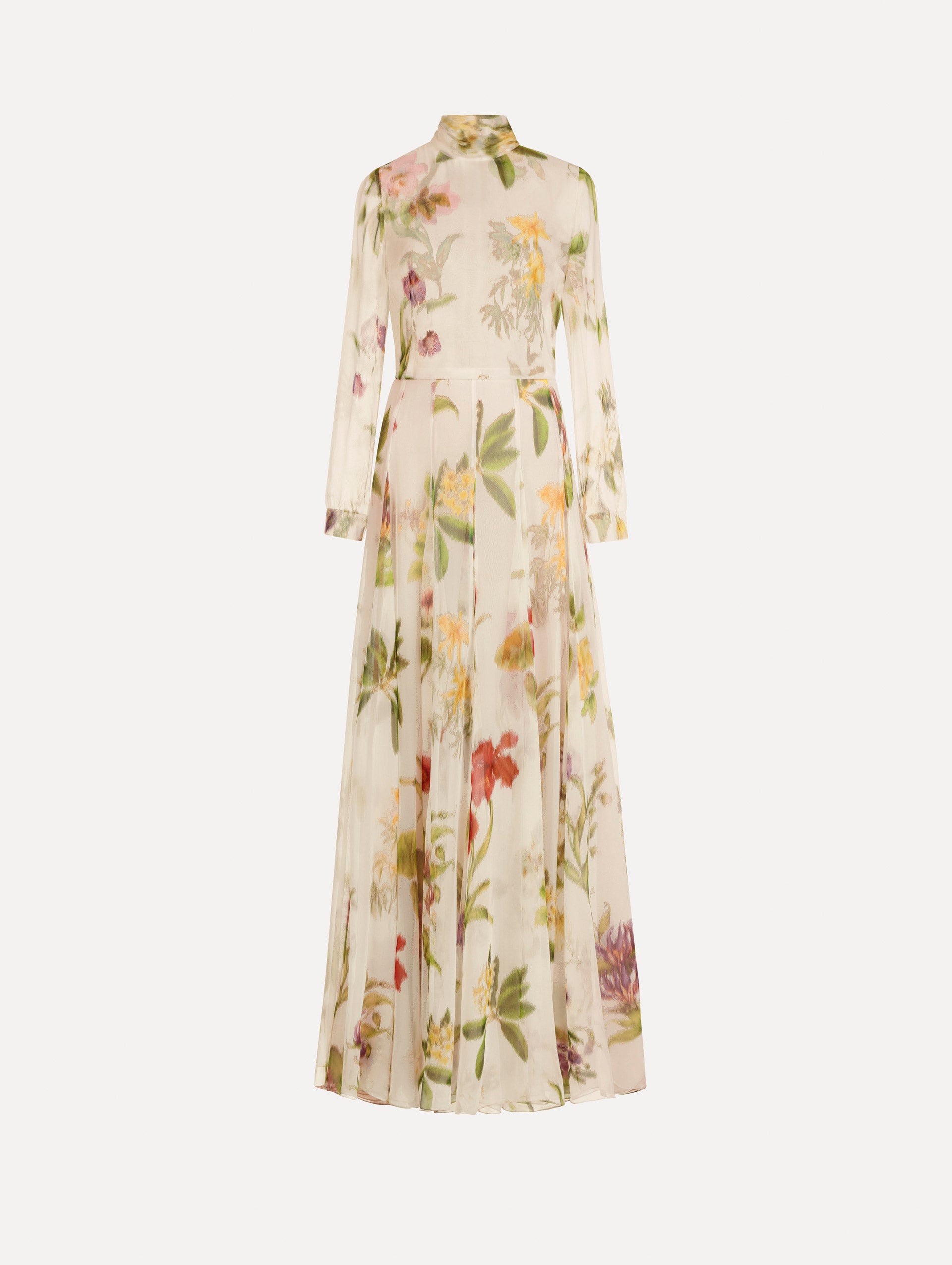 The Chiné Dominican Mixed-Floral Chiffon Gown in Ivory printed with an array of Dominican florals. Featuring long sleeves, mock neck, and flowing, pleated skirt. Front View.