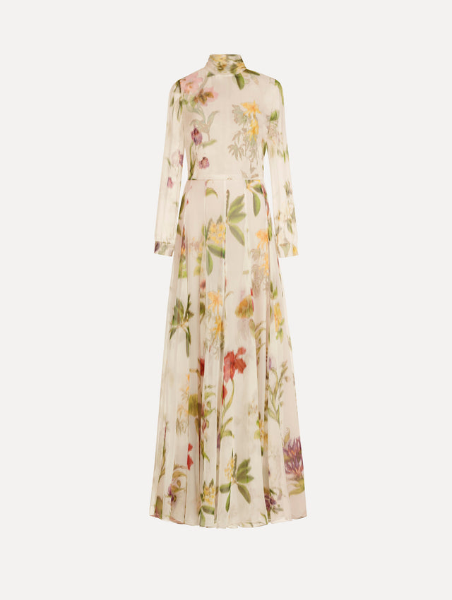 The Chiné Dominican Mixed-Floral Chiffon Gown in Ivory printed with an array of Dominican florals. Featuring long sleeves, mock neck, and flowing, pleated skirt. Front View.