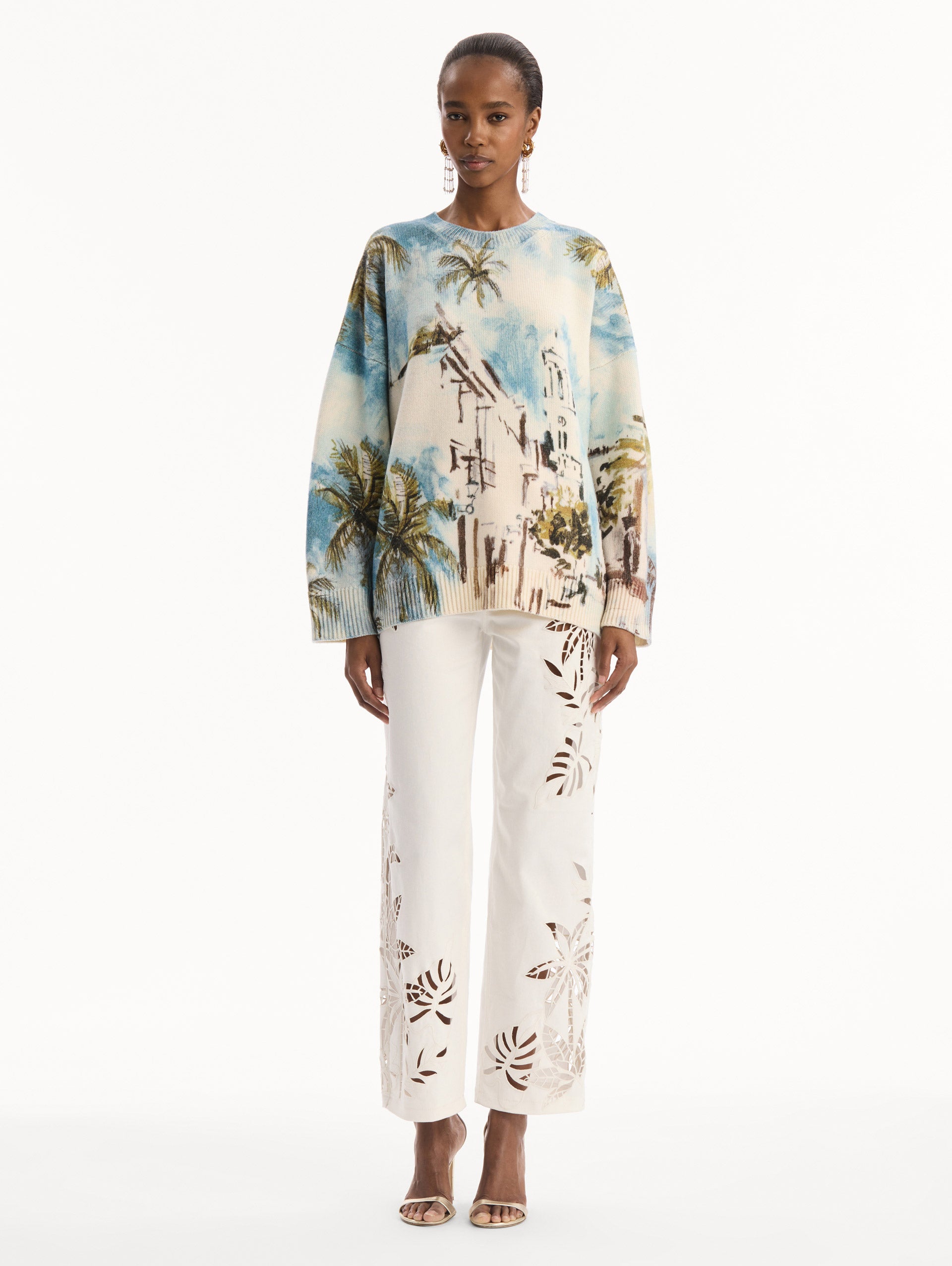 The model is wearing the Dominican Landscape Oversized Pullover. Featuring a crew neckline, long sleeves, ribbed trim, and an oversized fit. Front View.