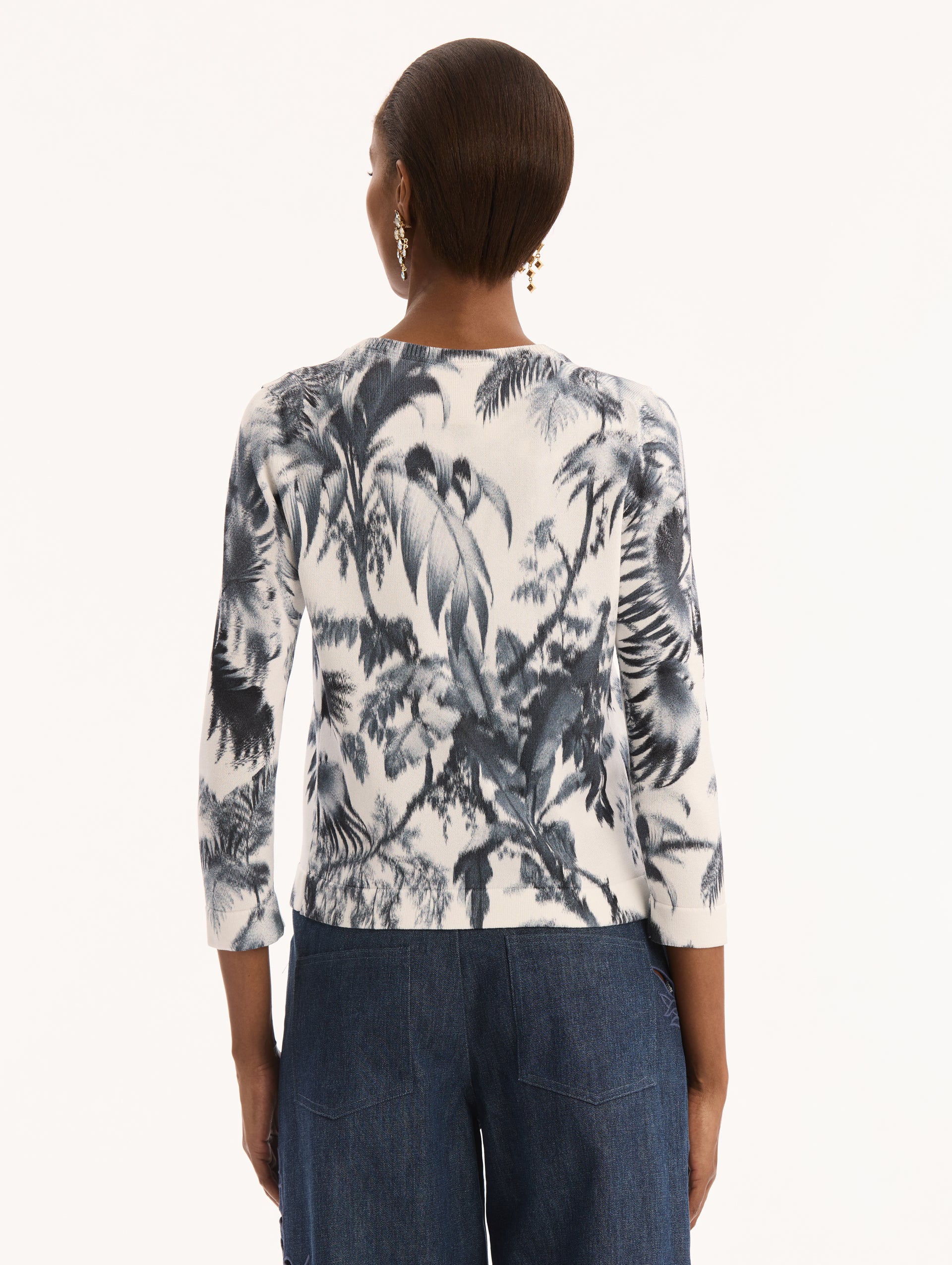 Ivory Three Quarter Length Sleeve Cardigan with Bow Tie Closure at Neck and Navy Chiné Palm Leaves Print. Back View. 