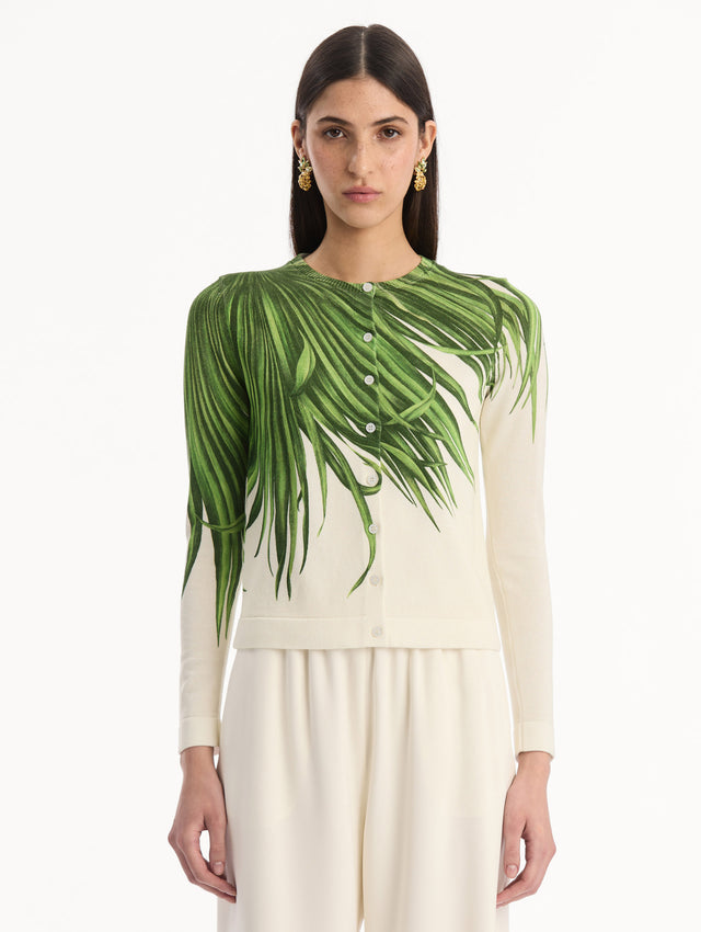 The model is wearing the Palm Leaves Cardigan in Green and Ivory. Featuring front button closures, a crew neckline, long sleeves, and banded trim. Front View.