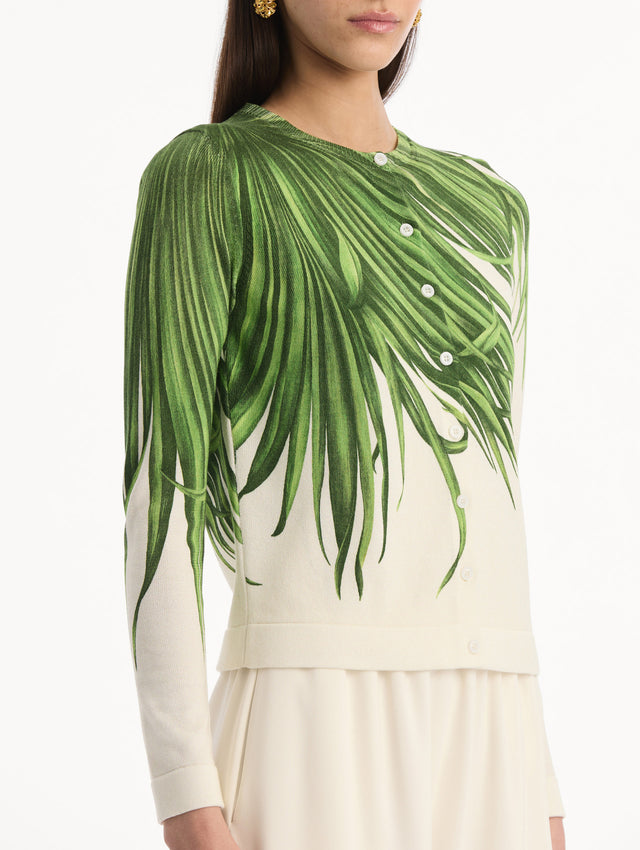 The model is wearing the Palm Leaves Cardigan in Green and Ivory. Featuring front button closures, a crew neckline, long sleeves, and banded trim. Detail View.