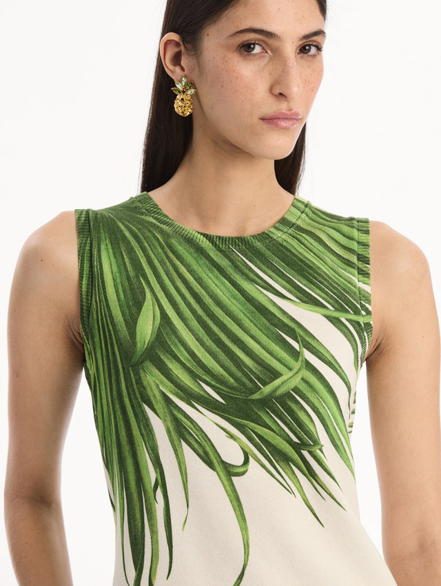 The model is wearing the Palm Leaves Tank in Green and Ivory. Featuring a crew neckline and banded trim. Detail View.