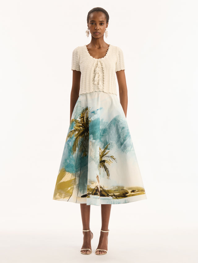 Ivory Pointelle Weave Cardigan. Shortsleeved, Scalloped edges. Bow and Tassel Closure. Front View.