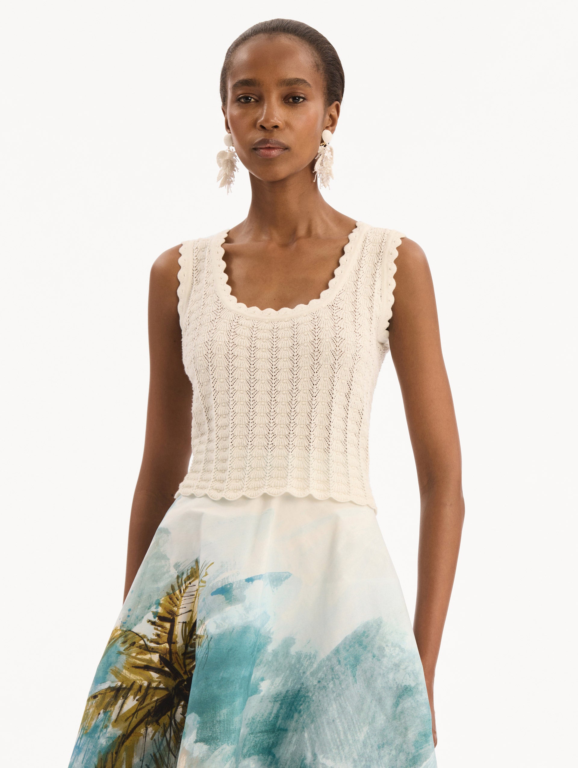 The model is wearing the Pointelle Weave Tank in Ivory. Featuring a scoop neckline, thick tank straps, and scalloped edges. Front View.
