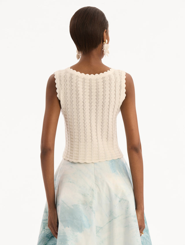 The model is wearing the Pointelle Weave Tank in Ivory. Featuring a scoop neckline, thick tank straps, and scalloped edges. Back View.
