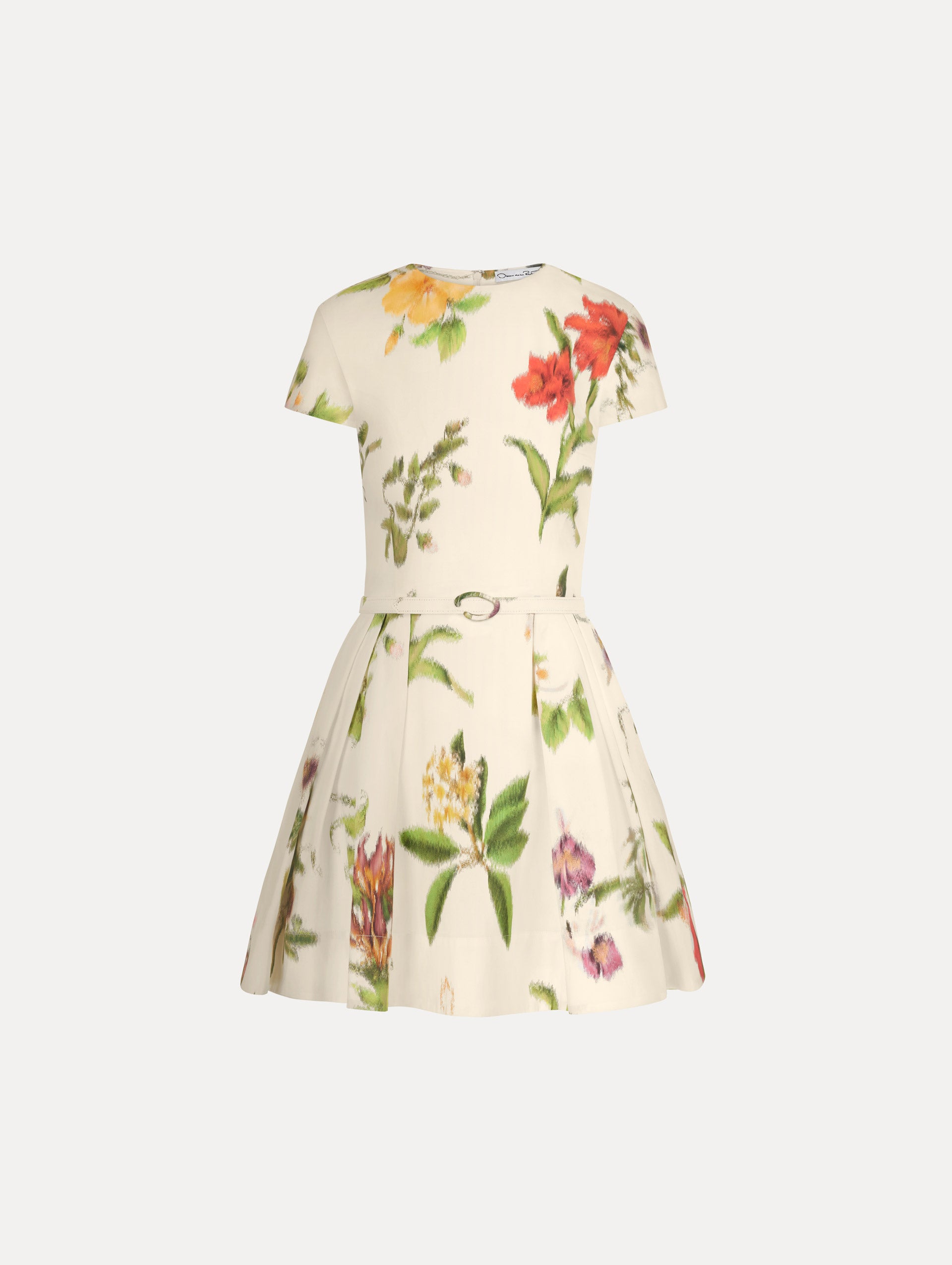 The Chiné Dominican Mixed-Floral Cotton Poplin Dress in Ivory printed with an array of Dominican florals. Featuring cap sleeves, belt at waist, and gathered mini skirt. Front View.