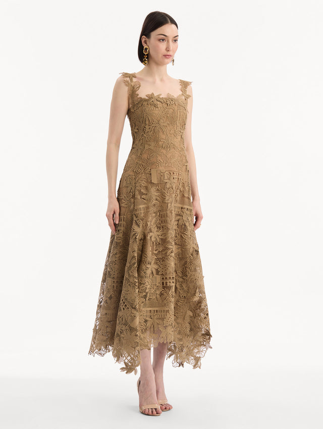 The model is wearing the Dominican Landscape Guipure Dress. Featuring a square neckline, tank straps, and lace guipure fabrication. Side View.