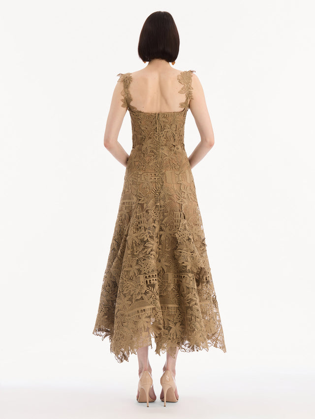 The model is wearing the Dominican Landscape Guipure Dress. Featuring a square neckline, tank straps, and lace guipure fabrication. Back View.