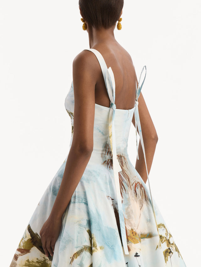 The model is wearing the Dominican Landscape Cotton Poplin Sleeveless Dress. Featuring tank straps with bow feature in back, and a full, midi-length skirt. Detail View.
