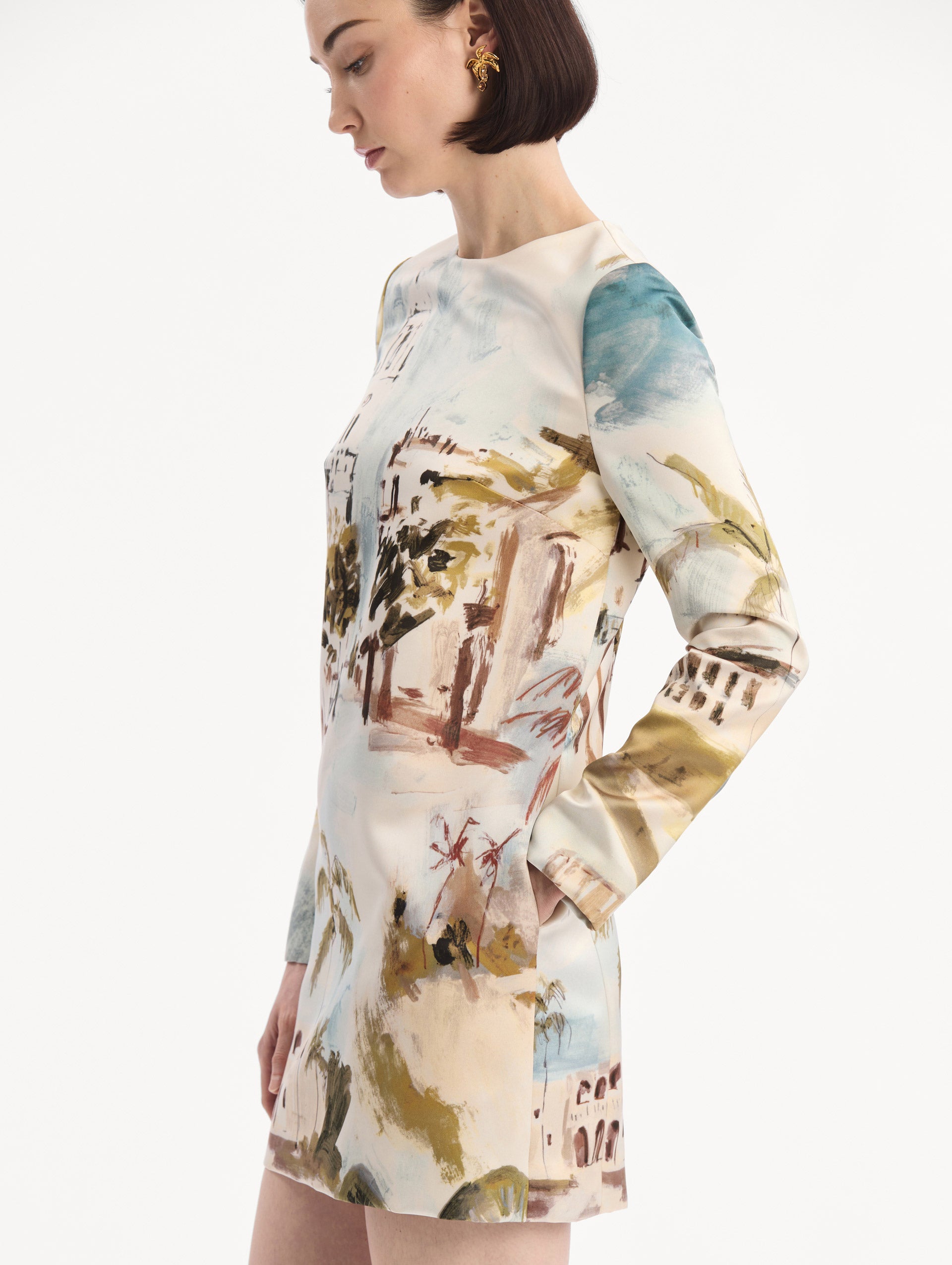 The model is wearing the Dominican Landscape Shift Dress. Featuring long sleeves and a mini length. Detail View.
