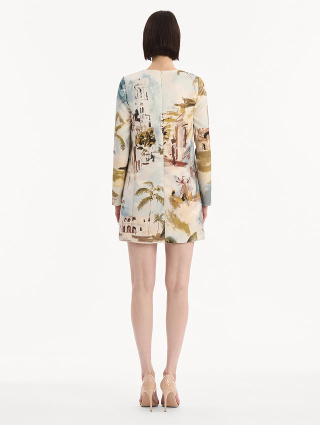 The model is wearing the Dominican Landscape Shift Dress. Featuring long sleeves and a mini length. Back View.