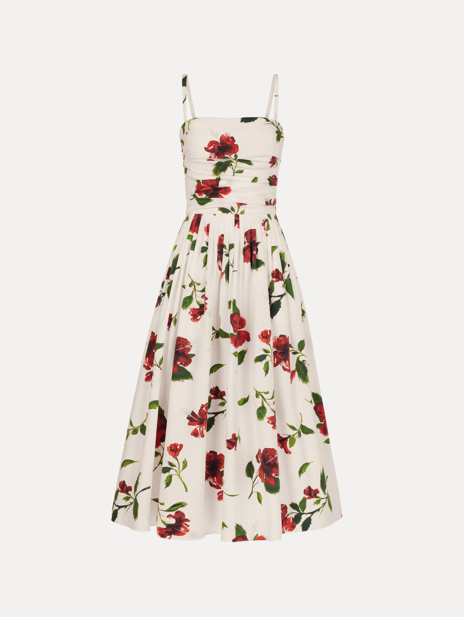 The Hibiscus Cotton Poplin Dress in white with red hibiscus blooms. Featuring a ruched bodice, tank straps, belt at waist, and full, gathered skirt. Front View.