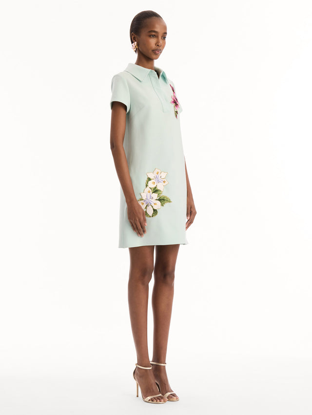 The model is wearing the Dominican Mixed-Floral Threadwork Shift Dress in Saltwater. Featuring open collar neckline and mini length. Side View.