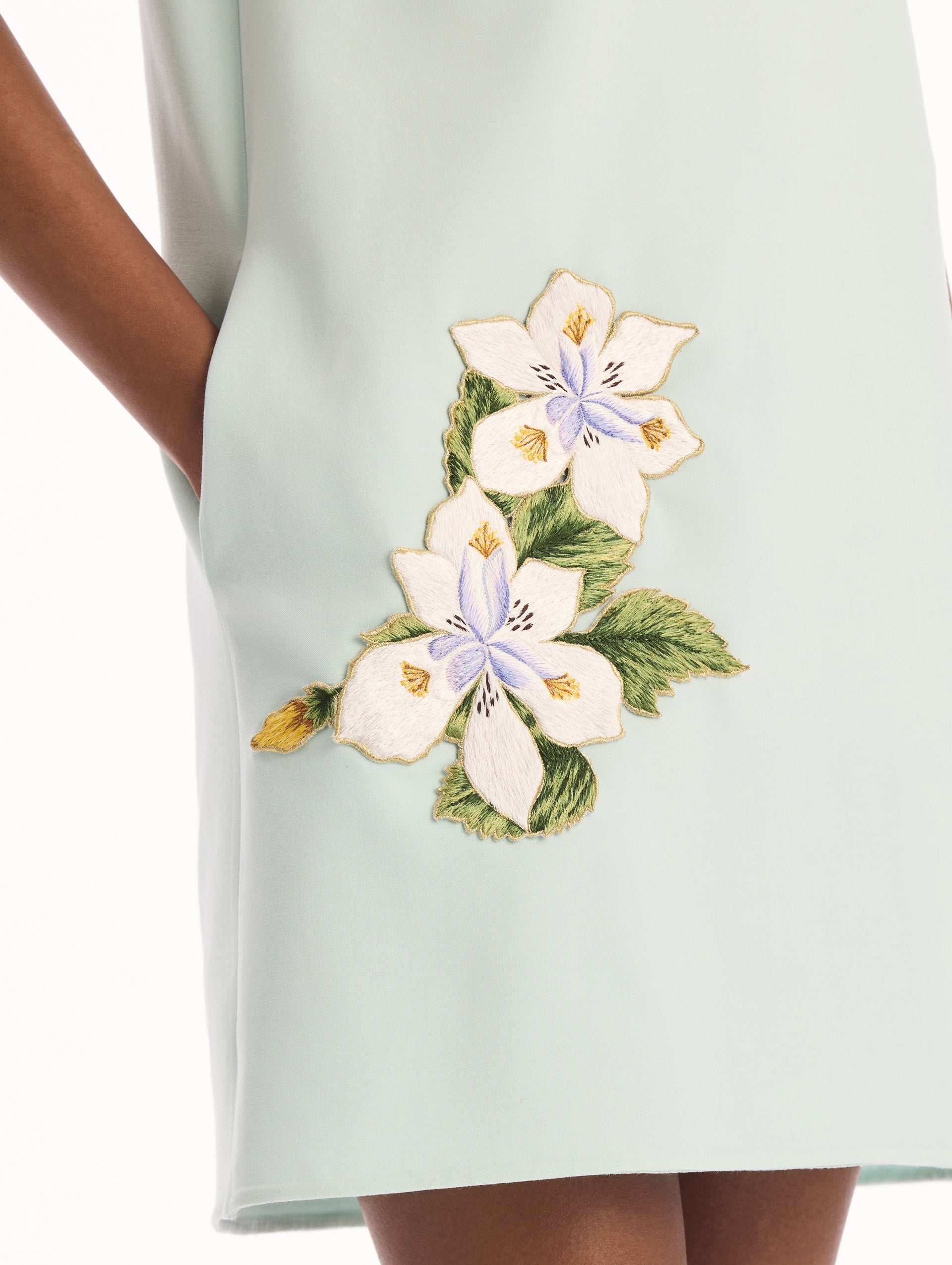 The model is wearing the Dominican Mixed-Floral Threadwork Shift Dress in Saltwater. Featuring open collar neckline and mini length. Detail View.