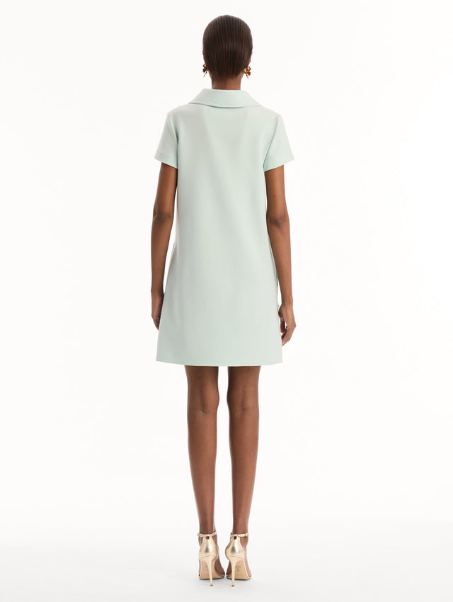 The model is wearing the Dominican Mixed-Floral Threadwork Shift Dress in Saltwater. Featuring open collar neckline and mini length. Back View.