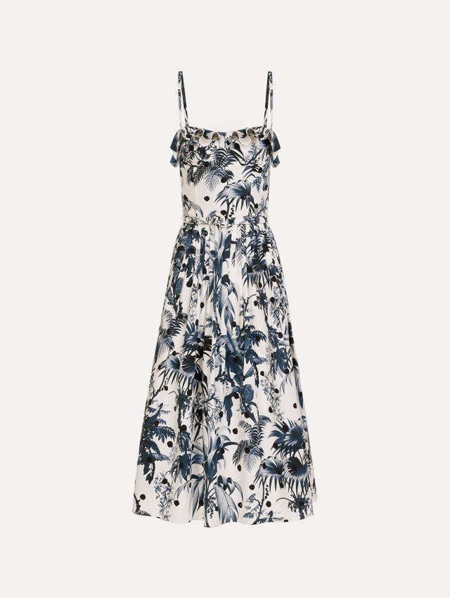 The Dotted Palm Leaves Cotton Poplin Sleeveless Dress in Navy Blue and White. Featuring a palm leaves print, ruffled top, delicate straps, belt at waist, softly structured bodice, and gathered skirt. Front View.
