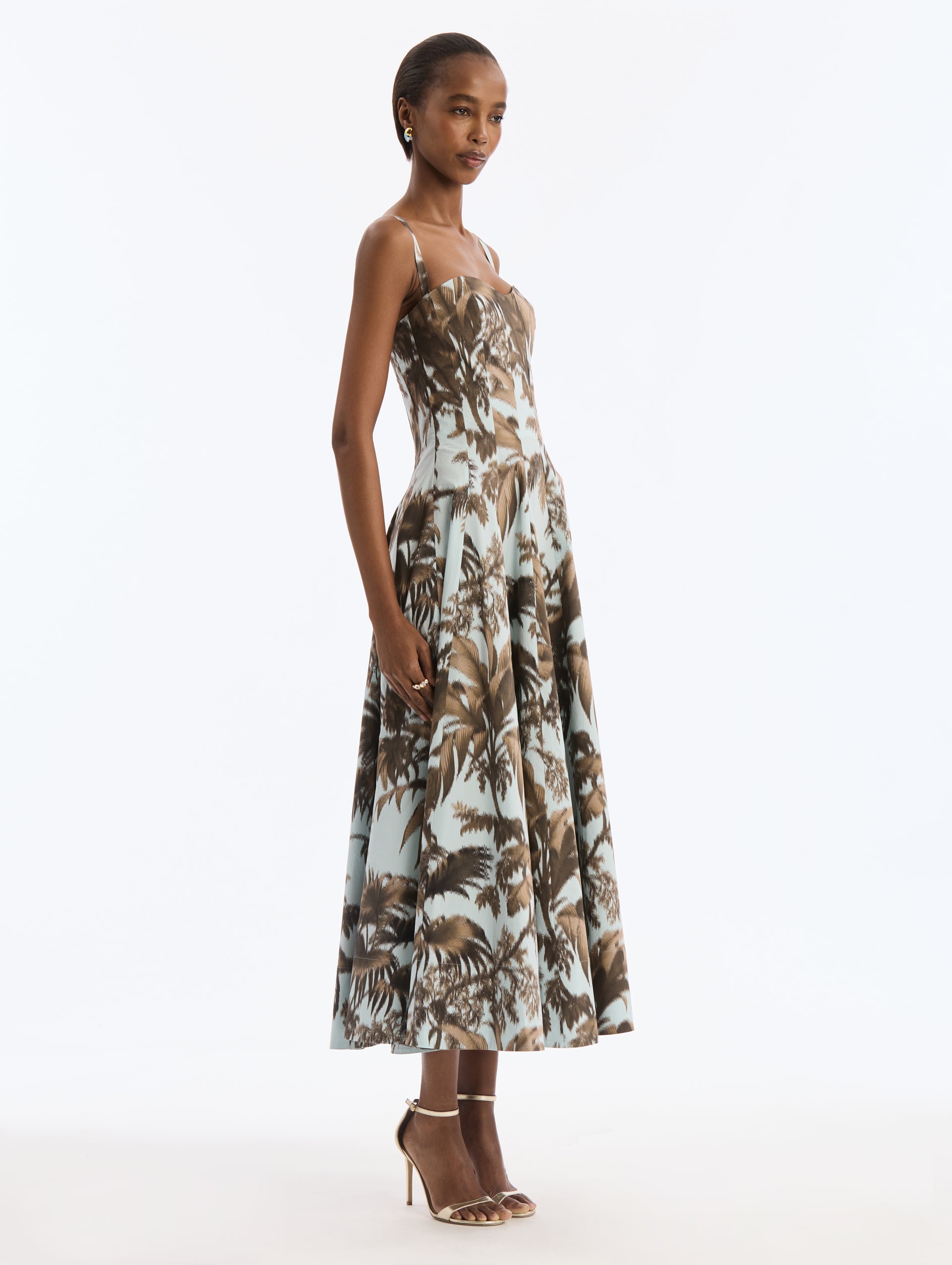 Blue Cotton Poplin Dress with Brown Chiné Palm Leaves. Delicate straps. Corseted Bodice, Pleated Skirt. Side View.