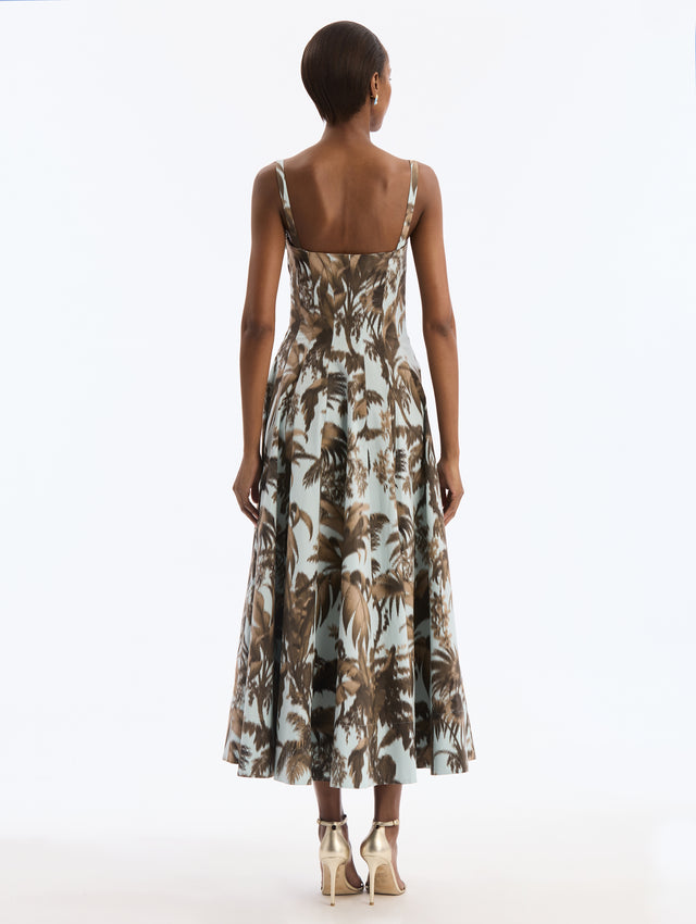 Blue Cotton Poplin Dress with Brown Chiné Palm Leaves. Delicate straps. Corseted Bodice, Pleated Skirt. Back View.