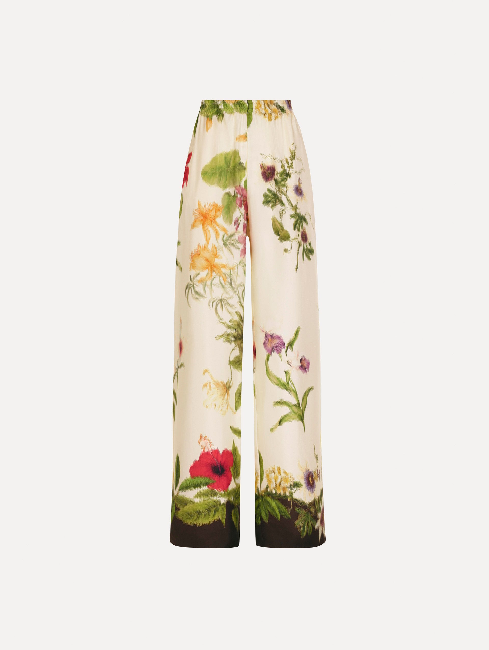 The Dominican Mixed-Floral Wide Leg Pant in ivory printed with an array of Dominican florals. Featuring wide legs and an elastic waistband. Front View.