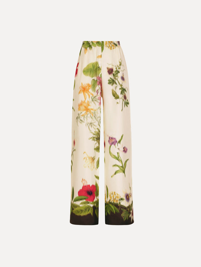 The Dominican Mixed-Floral Wide Leg Pant in ivory printed with an array of Dominican florals. Featuring wide legs and an elastic waistband. Front View.