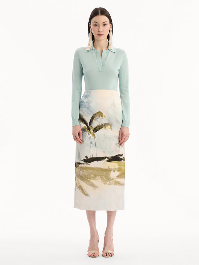 The model is wearing the Dominican Landscape Pencil Skirt printed in the Dominican landscape. Featuring a structured, column silhouette and midi length. Front View.