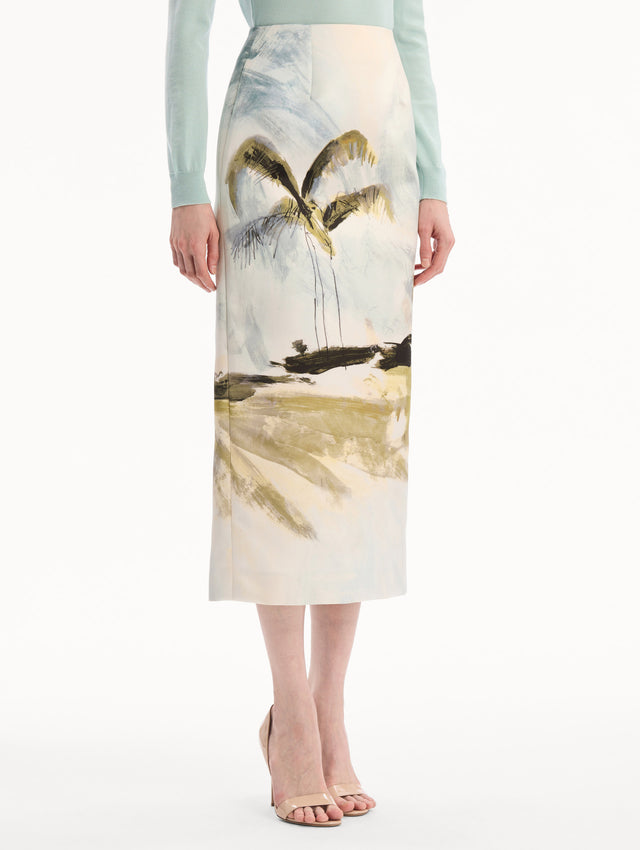 The model is wearing the Dominican Landscape Pencil Skirt printed in the Dominican landscape. Featuring a structured, column silhouette and midi length. Side View.