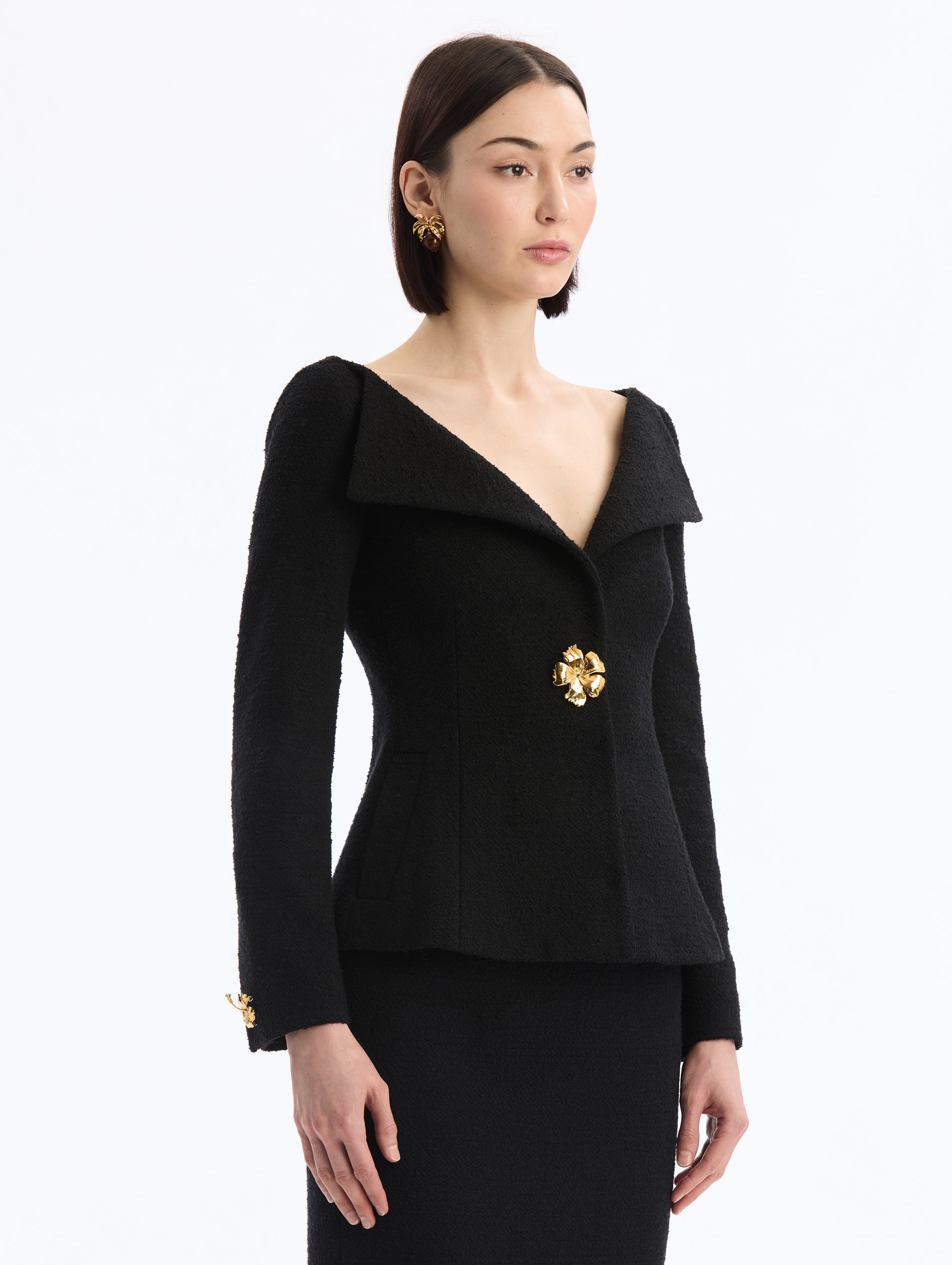 Black V-Neck Tweed Jacket with Gold Hibiscus Button. Side View. 