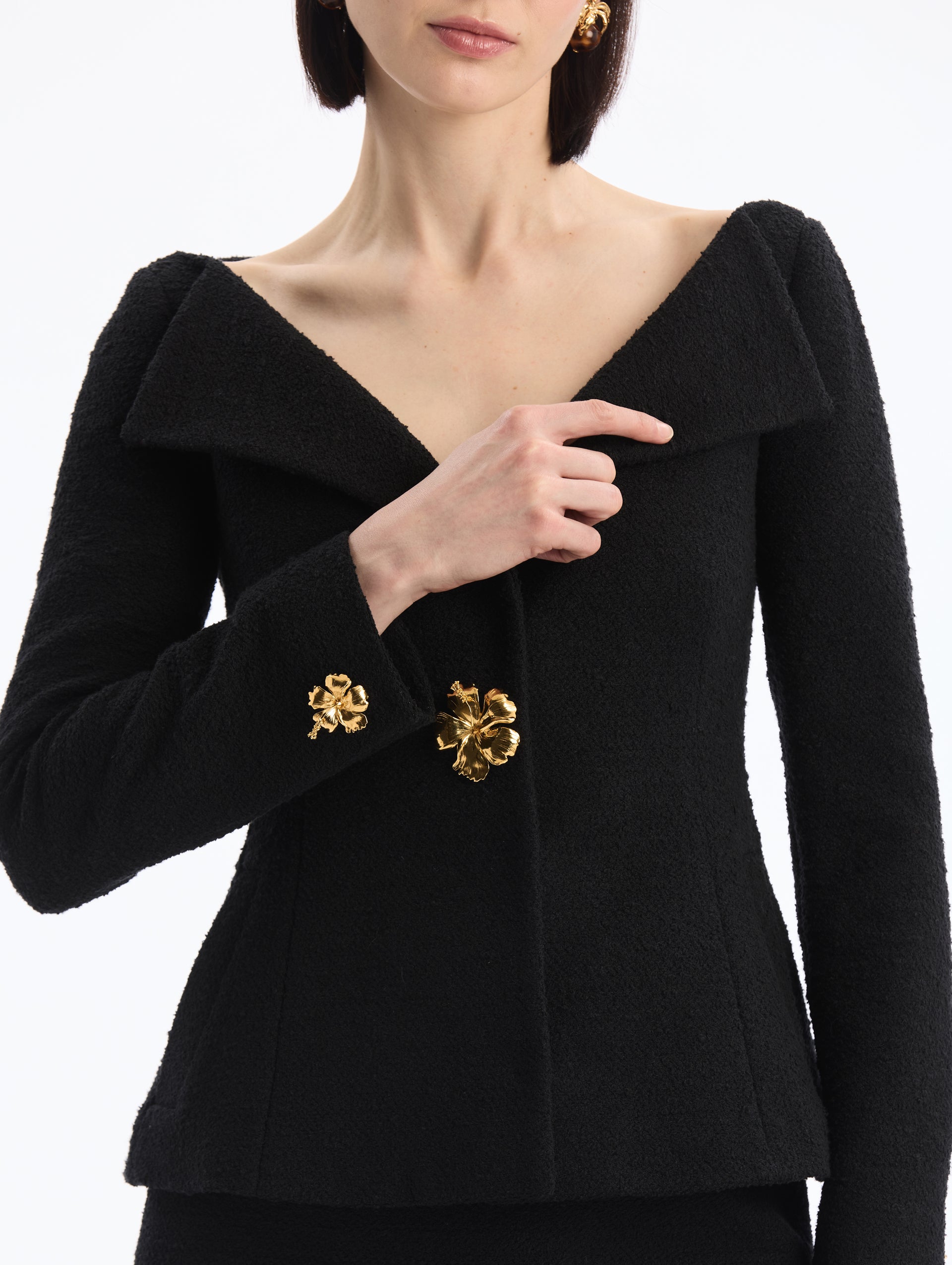 Black V-Neck Tweed Jacket with Gold Hibiscus Button. Close Up Front View. 