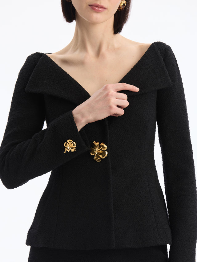 Black V-Neck Tweed Jacket with Gold Hibiscus Button. Close Up Front View. 