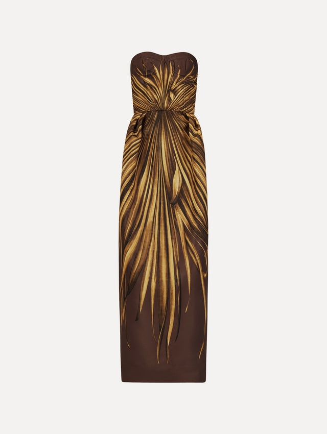The Palm Leaves Faille Gown in brown printed with gold palm leaves. Featuring a strapless neckline, sculpted bodice, and long skirt. Front View.