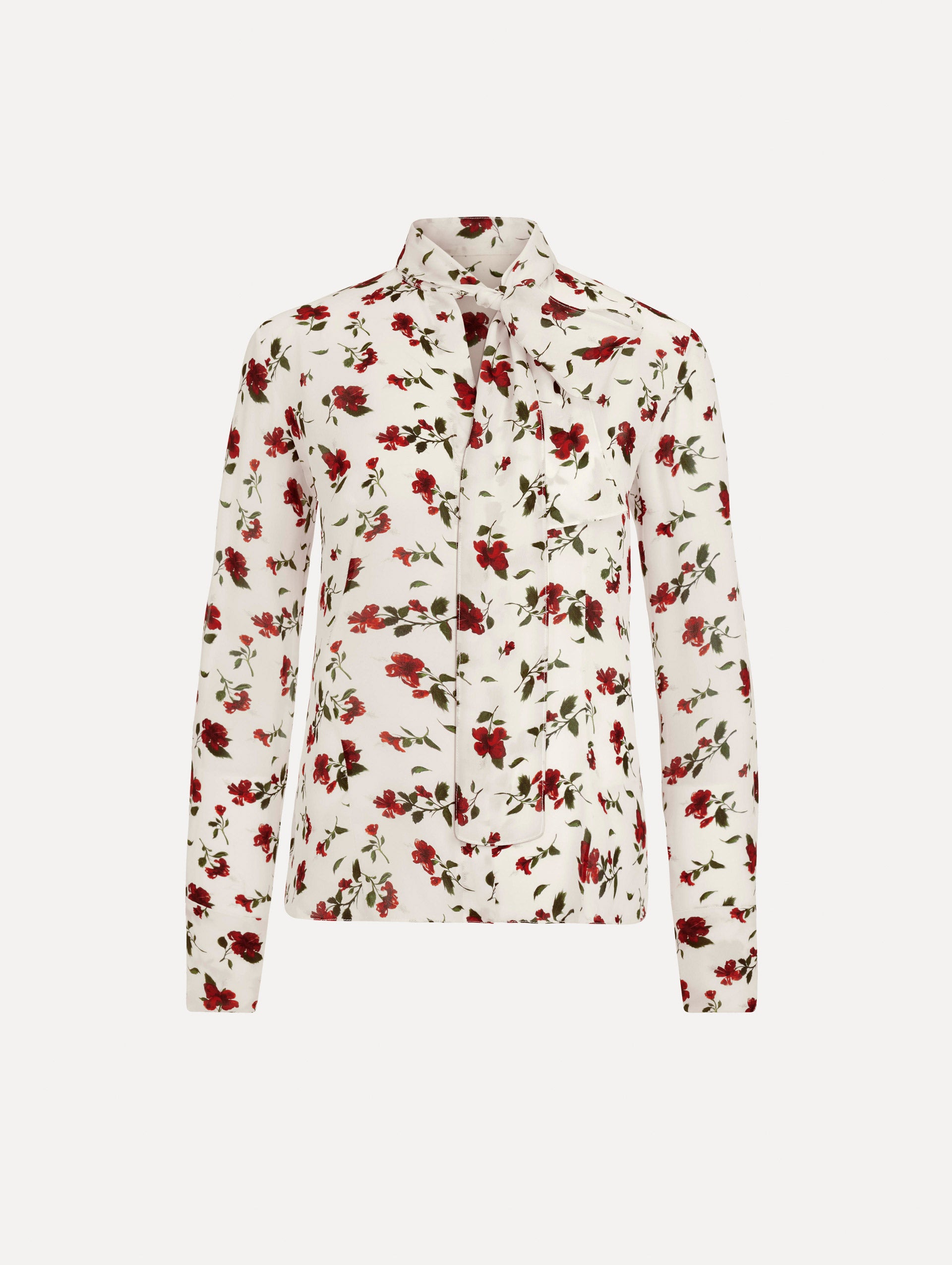 The Hibiscus Silk Chiffon Blouse in white printed with red hibiscus florals. Featuring a tie at neckline, long sleeves, and tailored silhouette. Front View.