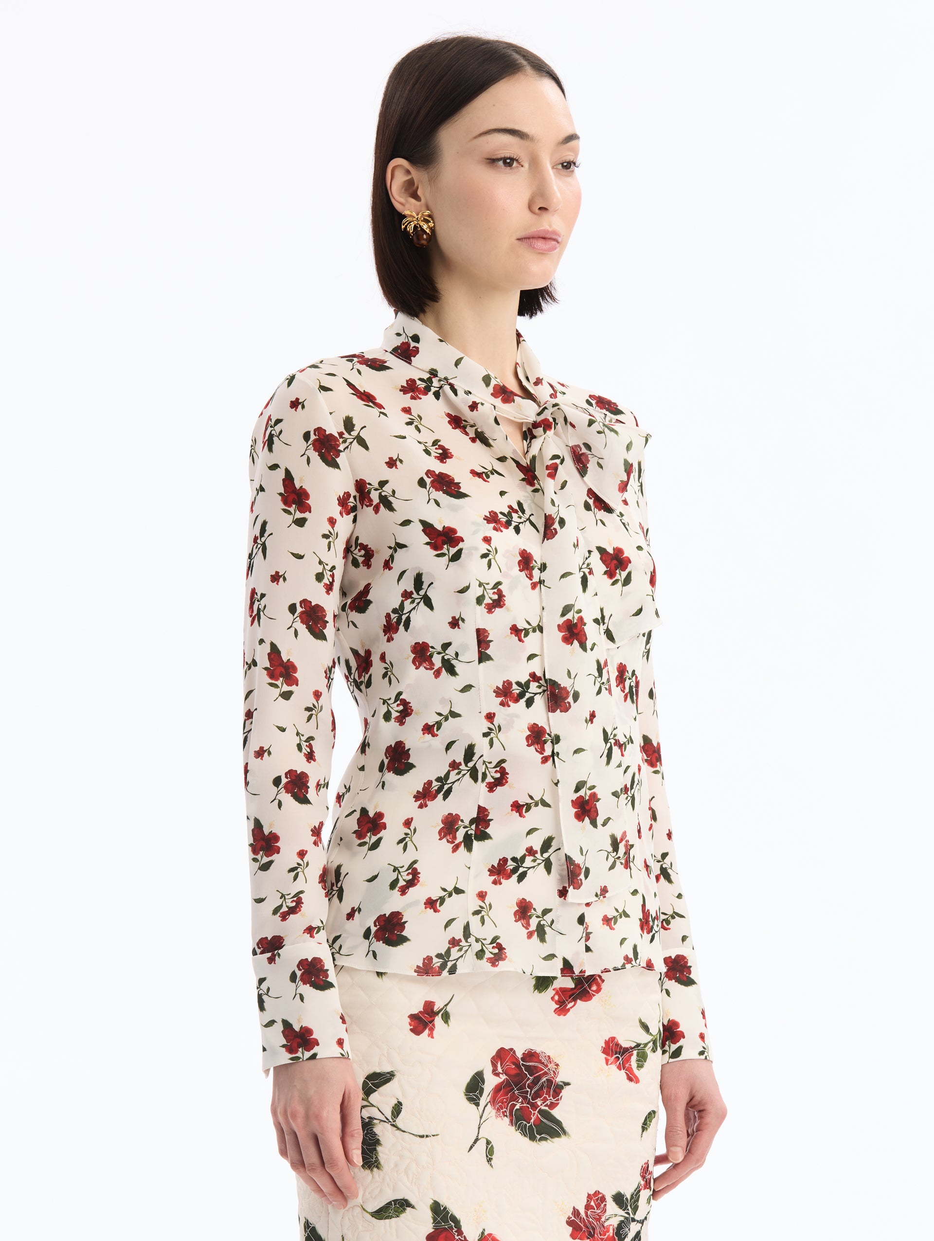 Long Sleeve White and Red Hibiscus Silk Blouse with Tied Neck. Side View. 