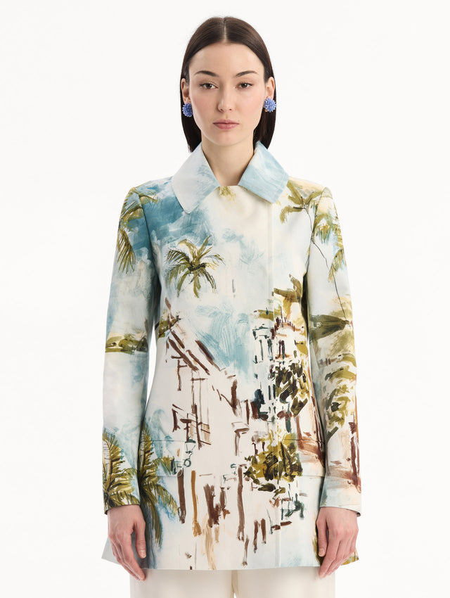 The model is wearing the Dominican Landscape Cotton Poplin Coat featuring an exaggerated collar, hidden buttons, front-flap pockets, and long sleeves. Front View.