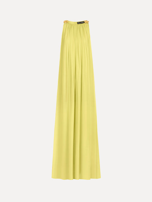 The Hibiscus-Detail Silk Chiffon Caftan in a light yellow-green color. Featuring a draping, gathered silhouette, long skirt, and sculptural hibiscus details at the shoulders. Front View.