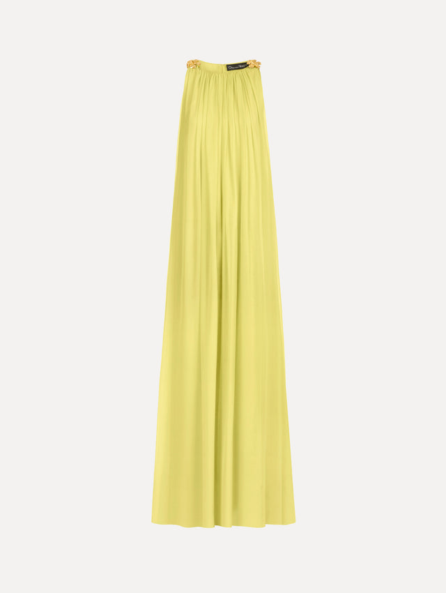 The Hibiscus-Detail Silk Chiffon Caftan in a light yellow-green color. Featuring a draping, gathered silhouette, long skirt, and sculptural hibiscus details at the shoulders. Front View.