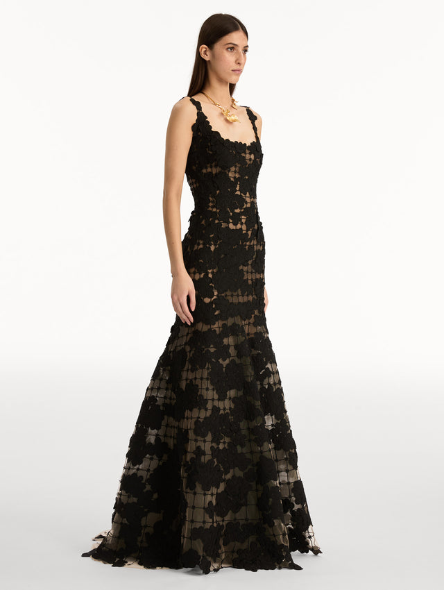 Black Floral Cutout Threadwork Gown with semi sheer floral pattern and flared floor length hem line. Side View.