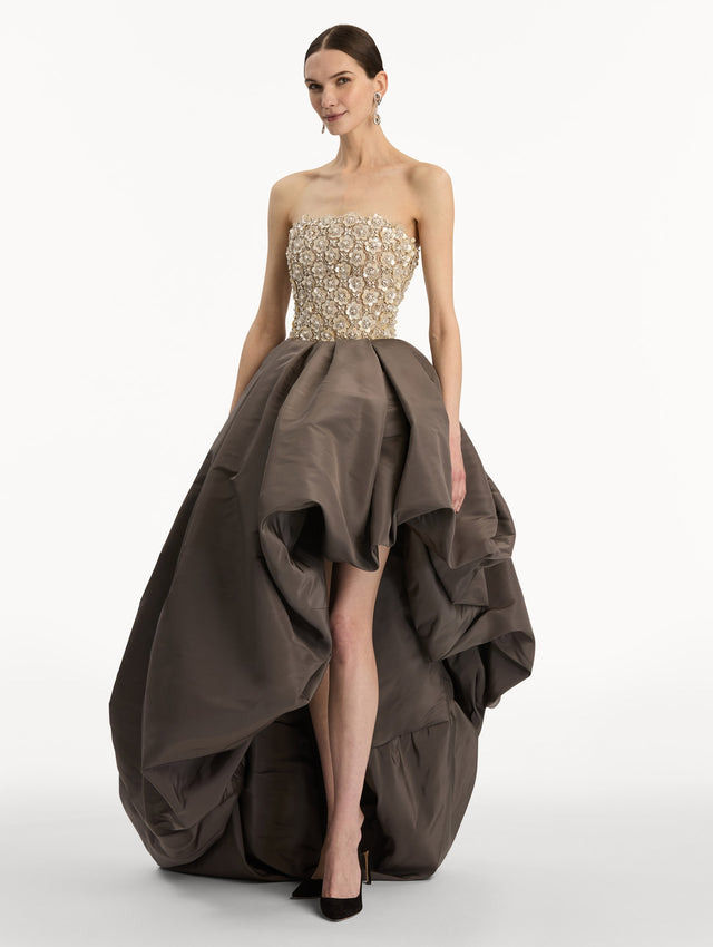 Brown and Beige Mother of Pearl Embroidered High-Low Gown with brown draped skirt and embroidered strapless bodice. Side View.