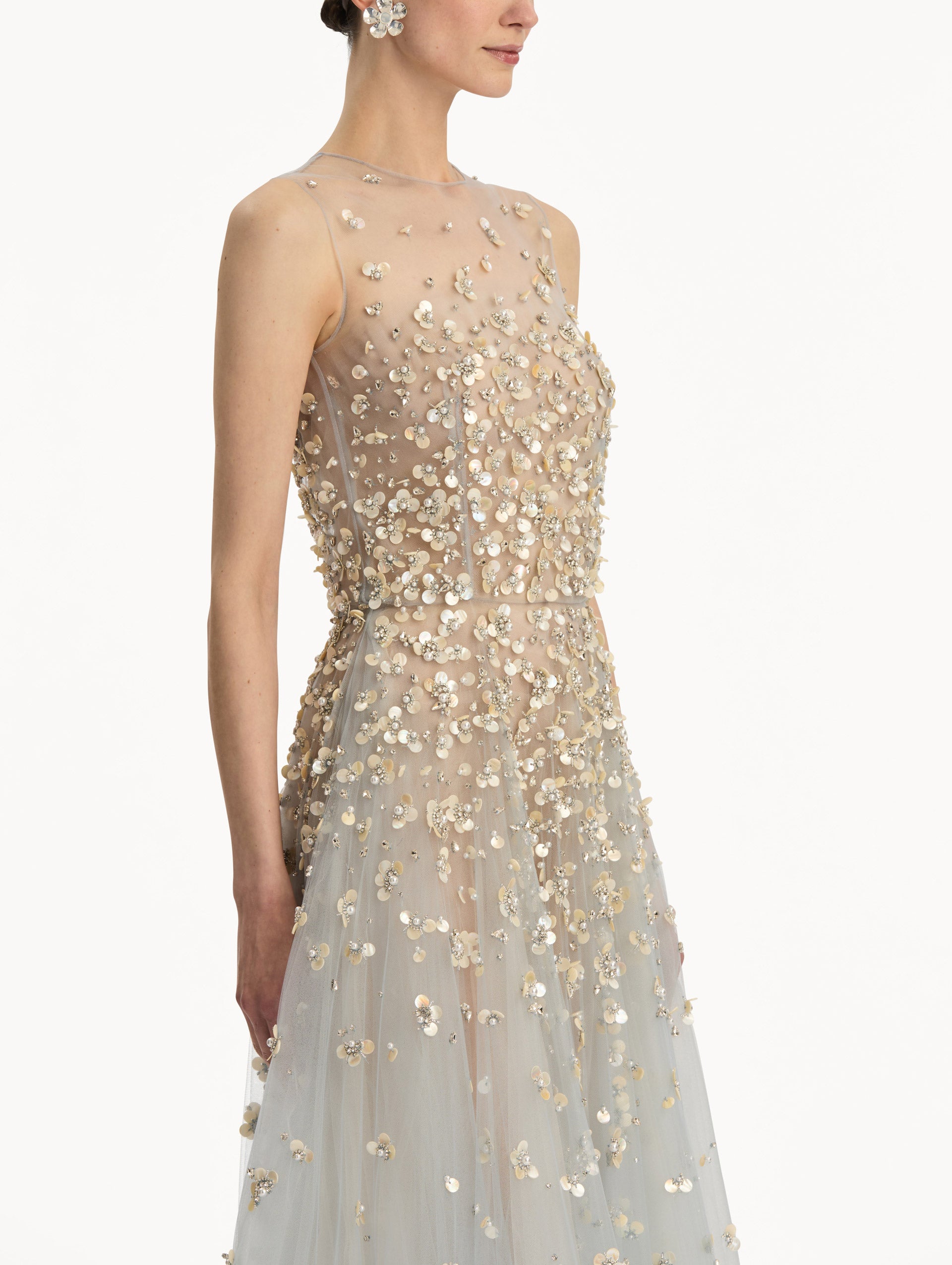 Tan and pale blue Mother of Pearl Embroidered Illusion Gown with flowing embellished skirt and scattered floral appliques. Zoom View.