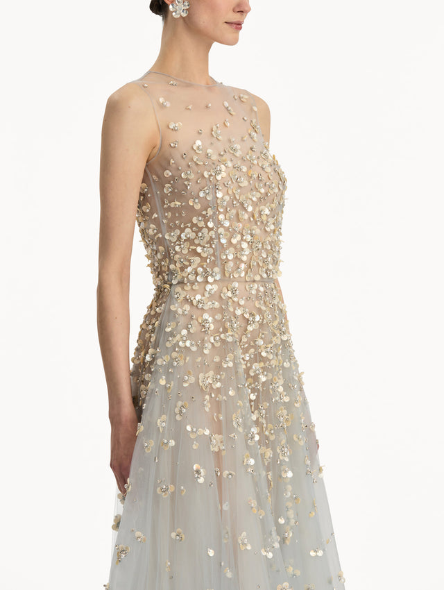 Tan and pale blue Mother of Pearl Embroidered Illusion Gown with flowing embellished skirt and scattered floral appliques. Zoom View.