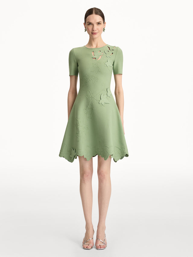 Green Ivy Cutout Knit Dress featuring short sleeves, leaf appliqué detailing, and scalloped hem. Front View.