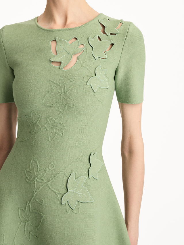 Green Ivy Cutout Knit Dress featuring short sleeves, leaf appliqué detailing, and scalloped hem. Zoom View.