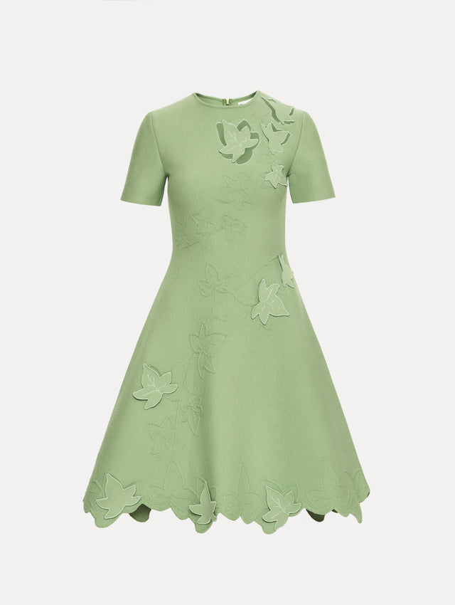 Green Ivy Cutout Knit Dress featuring short sleeves, leaf appliqué detailing, and scalloped hem.
