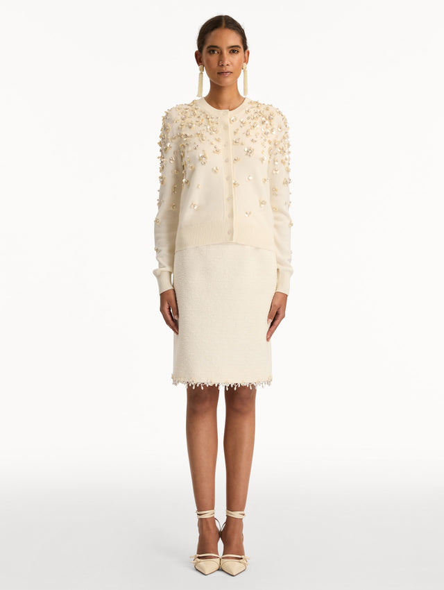 Ivory Mother of Pearl Embroidered Cardigan featuring a crew neckline, button front, and sequin floral embellishments throughout. Front View.