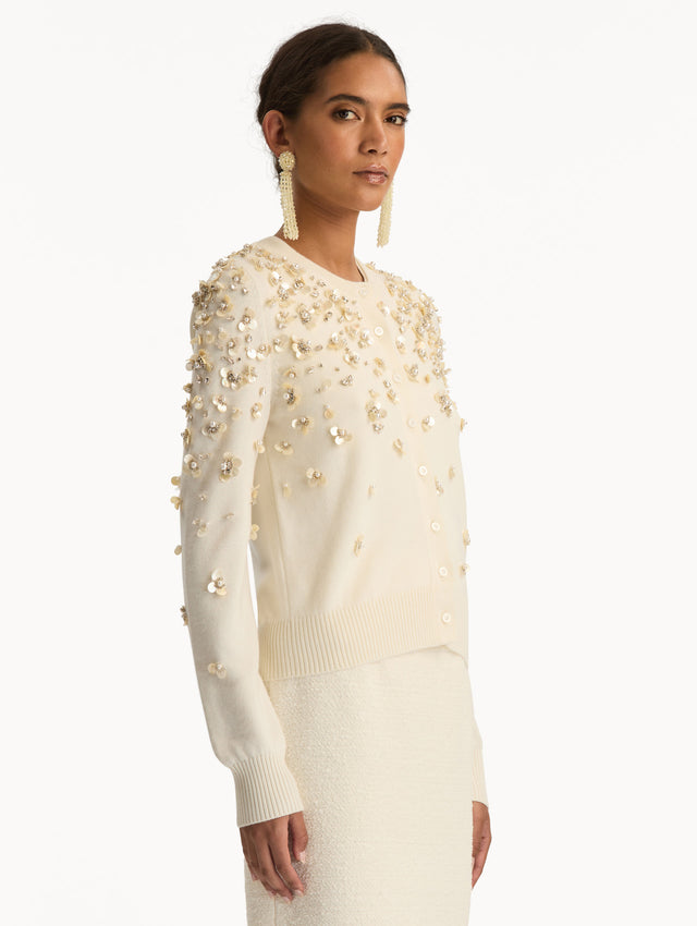 Ivory Mother of Pearl Embroidered Cardigan featuring a crew neckline, button front, and sequin floral embellishments throughout. Side View.