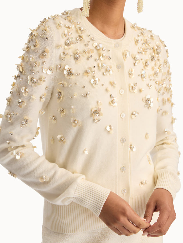 Ivory Mother of Pearl Embroidered Cardigan featuring a crew neckline, button front, and sequin floral embellishments throughout. Zoom View.