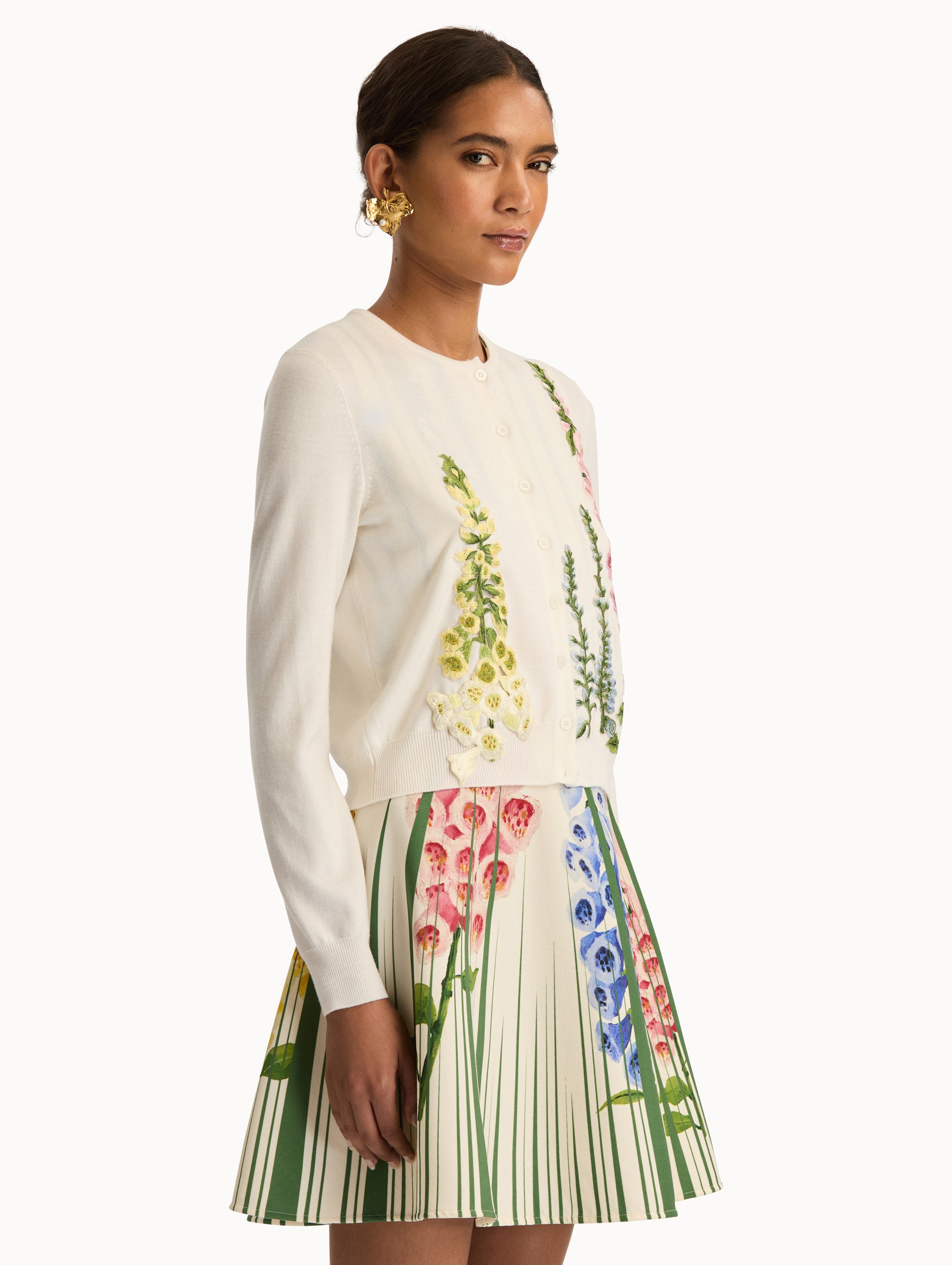 White Foxglove Threadwork Cardigan with climbing yellow and pink floral applique. Side View.