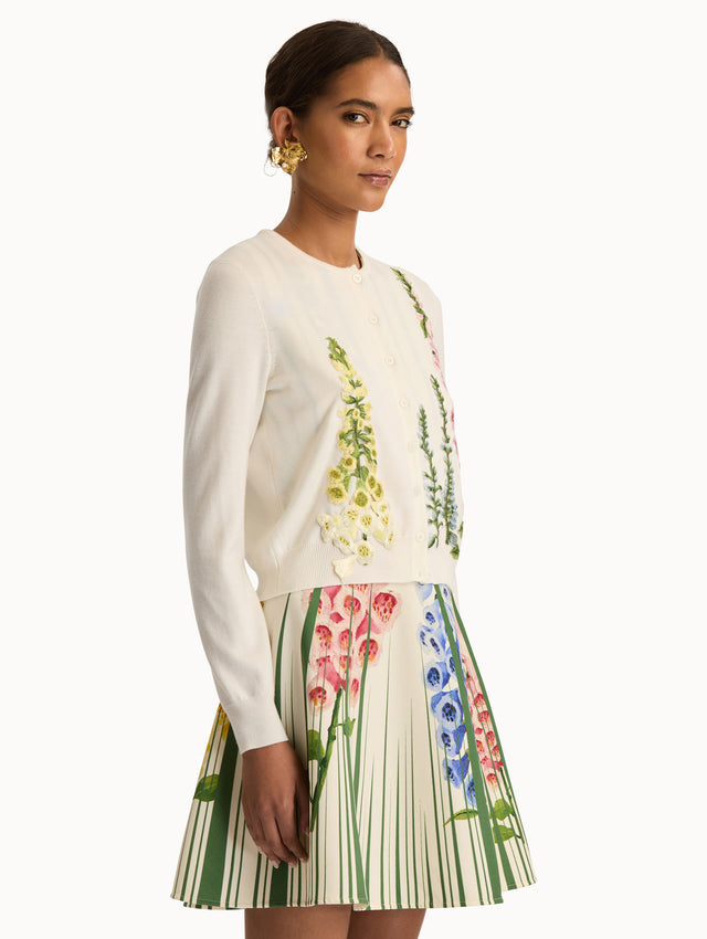 White Foxglove Threadwork Cardigan with climbing yellow and pink floral applique. Side View.
