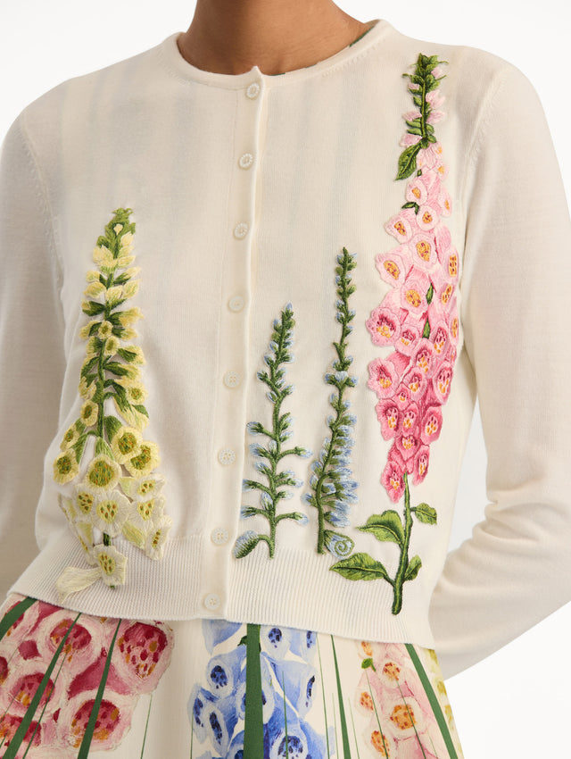 White Foxglove Threadwork Cardigan with climbing yellow and pink floral applique. Zoom View.